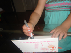 Emily signs her thank you notes